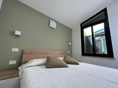 Letto o letti in una camera di Appartamento vicino spiaggia