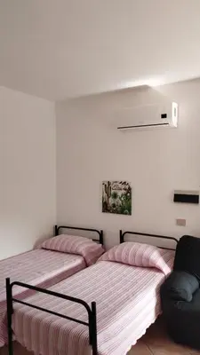 Letto o letti in una camera di CannonHouse - La Pavoncella Rosa