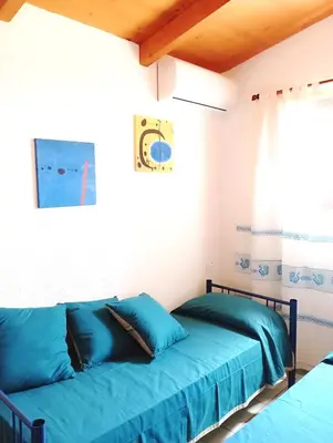 Letto o letti in una camera di Villa Milena Costa Rei VISTA MARE