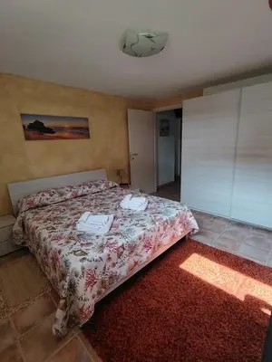 Letto o letti in una camera di STELLA MARINA, Appartamento a 450 mt dalla costa del Mar di Sardegna